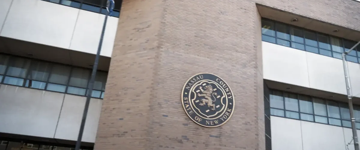 Long Island eviction court building with Nassau County seal.